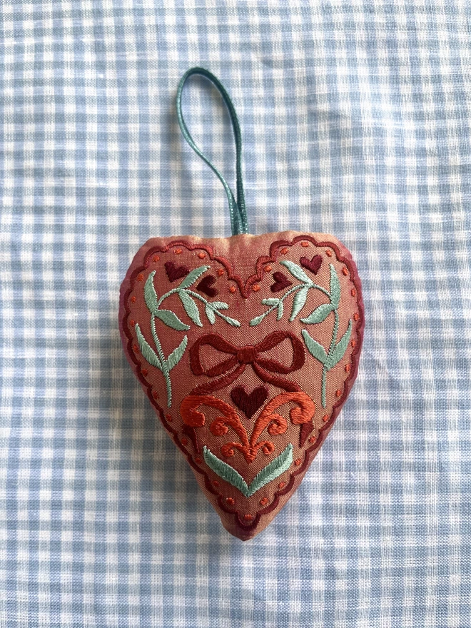 Silk ornament with hand-guided embroidery (peach silker with brown, orange and mint green thread)