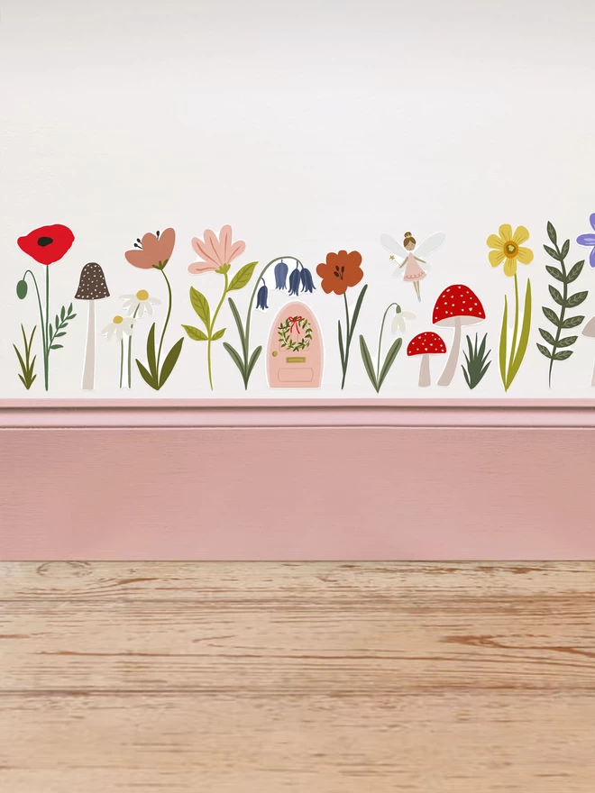 Fairy Door and Forest Flower wall stickers above pink painted skirting board
