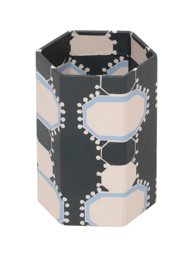 Tijan Hexagonal Brush Pot, a colourful patterned pencil pot sitting on a white surface against a plain backdrop. 