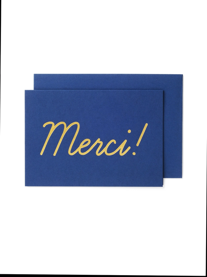Luxury gold foil Merci thank you type on navy blue card with matching heavyweight peel and seal envelope 