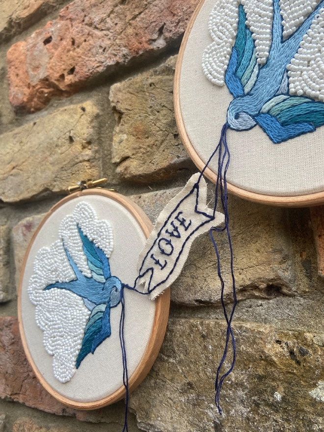 Blue swallows in embroidery hoops