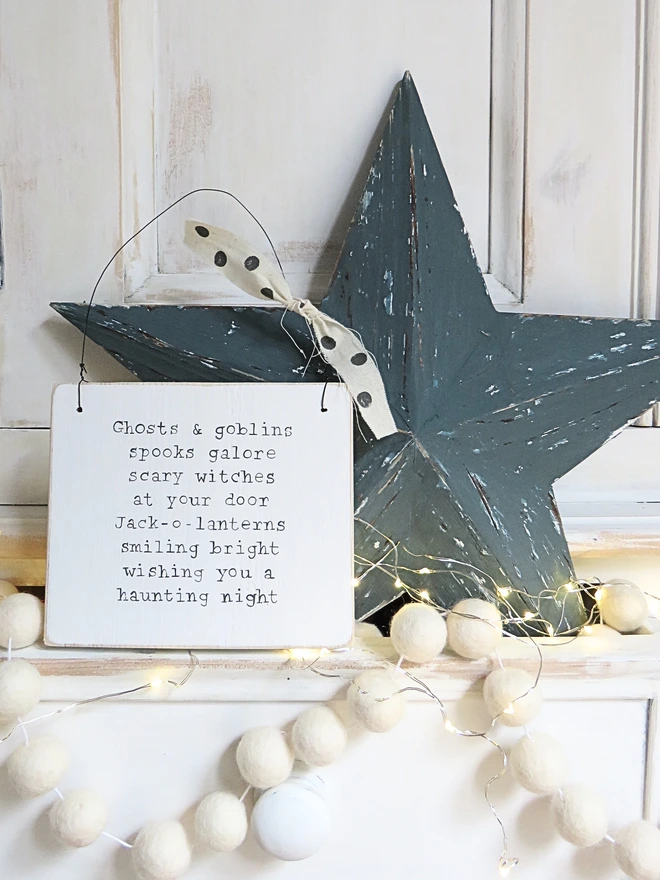 hand painted wooden sign with ghosts and goblins rhyme and spotty ribbon detail