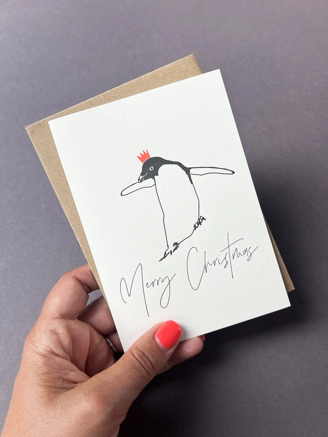 Cute Penguin wearing a neon Christmas party hat.