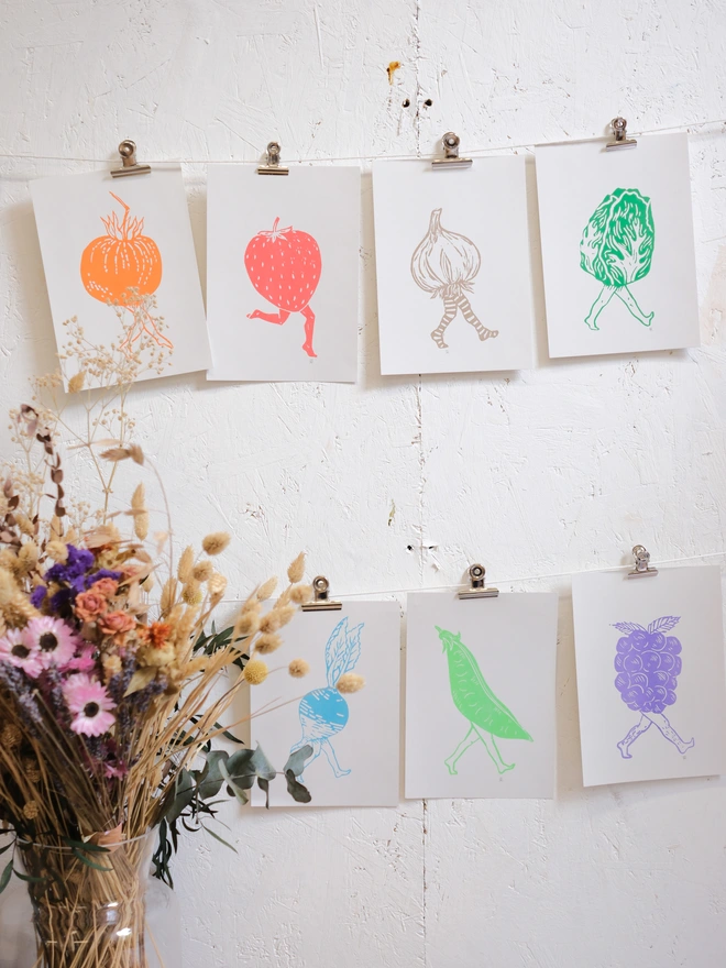 a wall of fruit and veg prints with legs