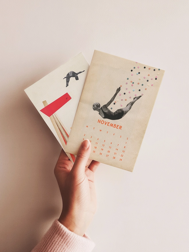Two pages of a desk calendar held in a hand.
