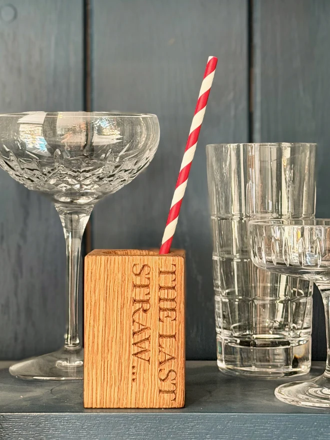 Stripy straws in a straw cup with engraving that says It's the last straw...