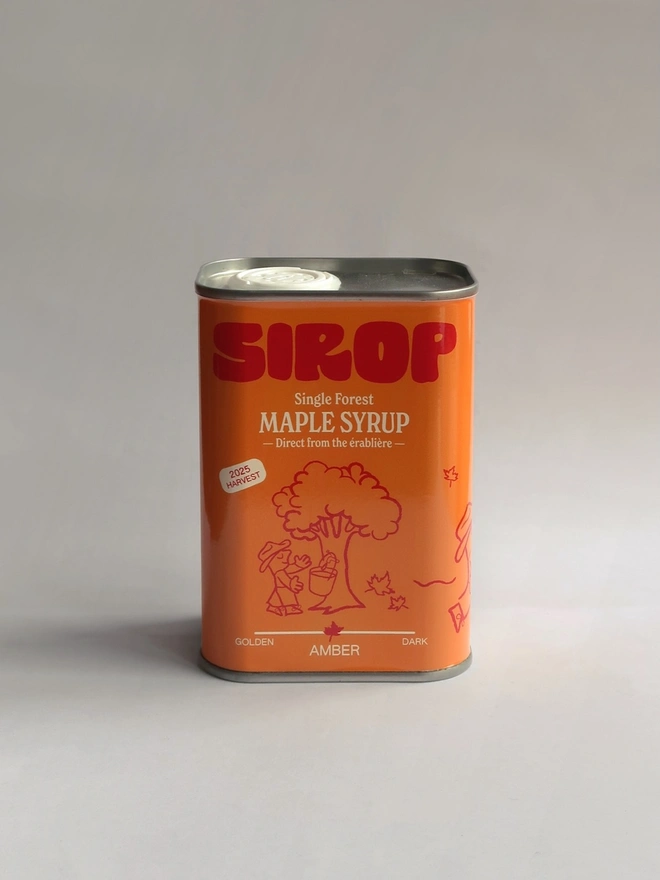 metal container with orange label, which reads 'sirop single forest maple syrup'