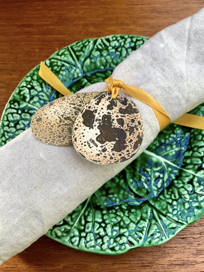 speckled egg napkin ties with gold ribbon