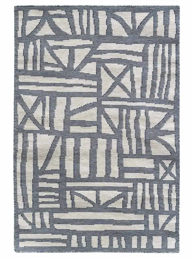 Tudor Flatweave Rug, a colourful rug on a white surface. 