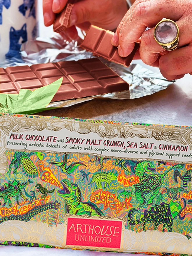 Milk chocolate with smoky malt crunch, sea salt & cinnamon in gold foiled card decorated with dinosaurs