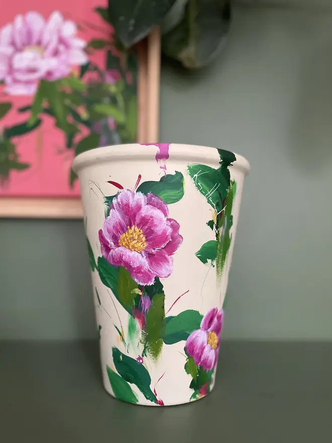 hand painted floral terracotta plant pot cream background with pink peony flowers.