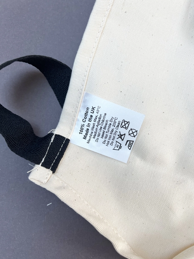 Close up of the care label on the top of the apron