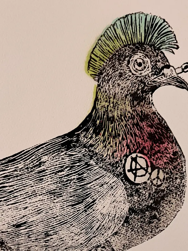 Punk pigeon lino print, with symbols, coloured with blue and pink paint with on a white background. 