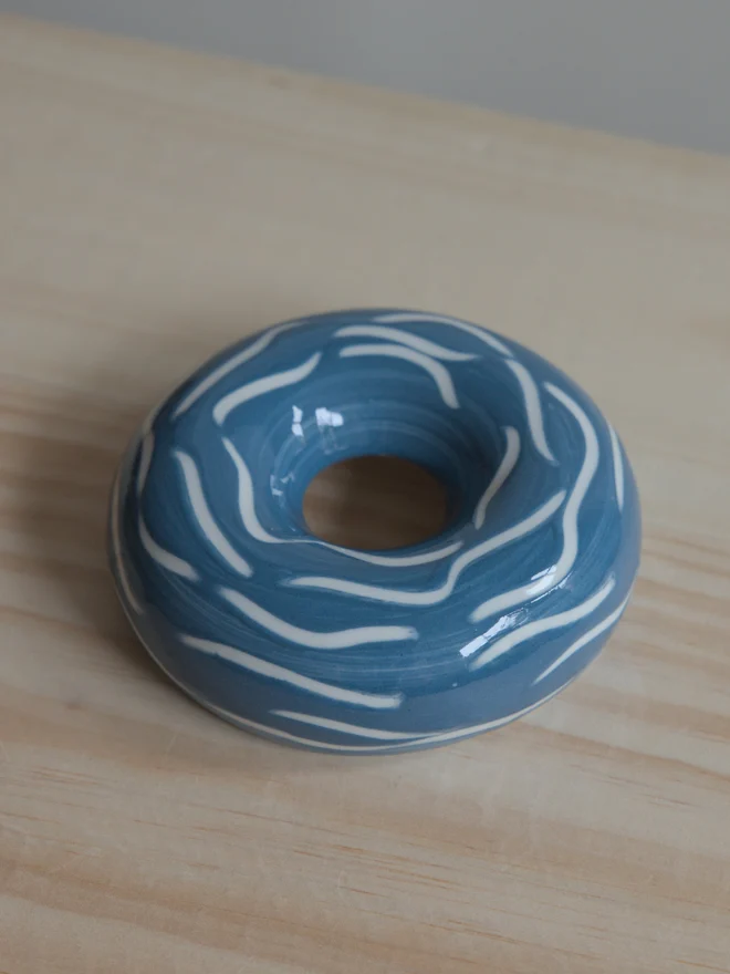 Handmade porcelain avocado planter with carved blue pattern, designed to hold an avocado seed for sprouting