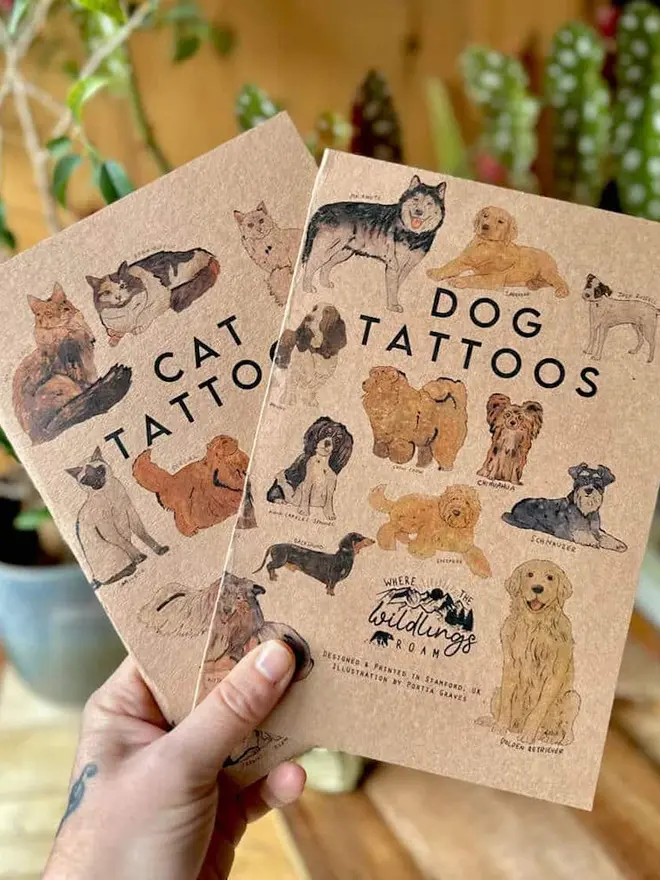 Pets Temporary Tattoos, A hand holds two brown kraft paper tattoo booklets titled "CAT TATTOOS" and "DOG TATTOOS."