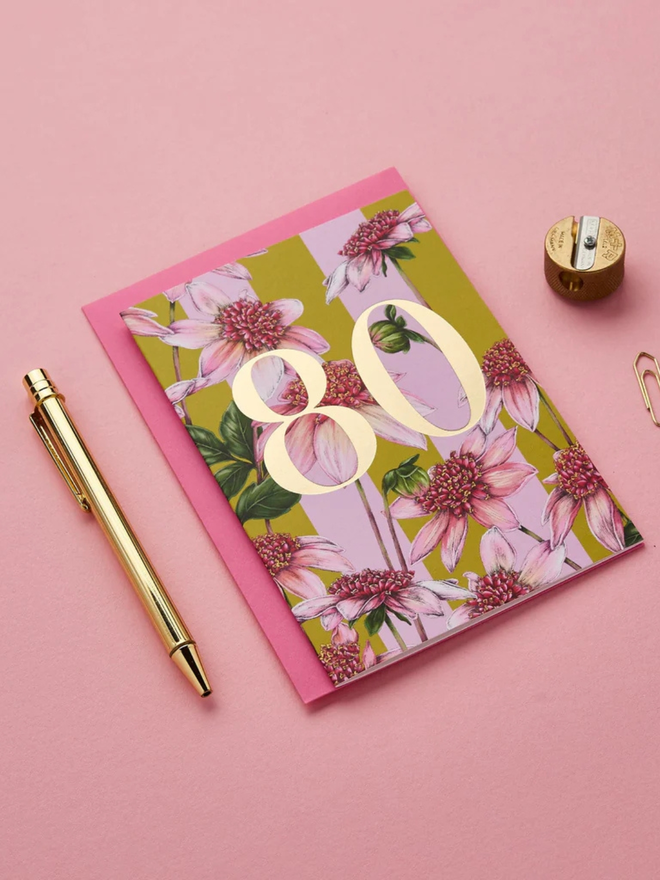 floral age milestone card. a pink floral 80th birthday card photographed against a pink background.