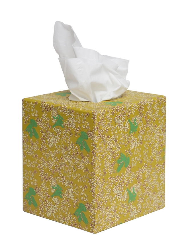 Corali Tissue Box Cover, a colourful and patterned tissue box sitting on a white surface against a plain backdrop. 