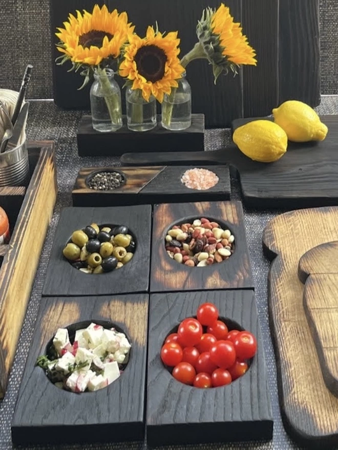 Charred Nibble Bowls With Snacks on a Table with Flowers