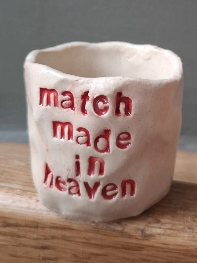 Short Ceramic Match Holder with the phrase 'Match made in heaven' stamped into it 