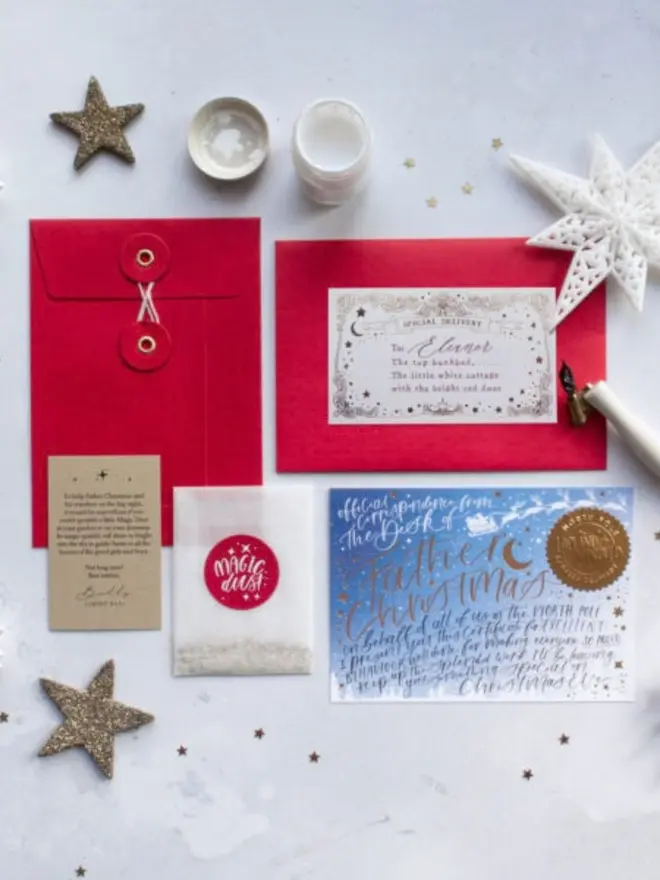 The blue certificate with red envelopes, a Magic Dust packet and a Chief Elf note.