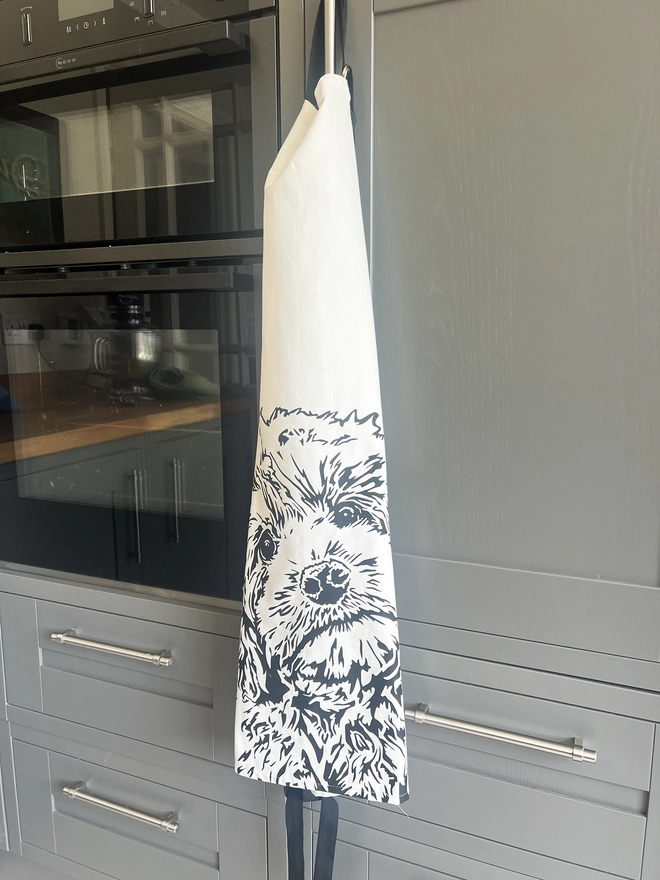 Cockapoo apron hanging from oven door