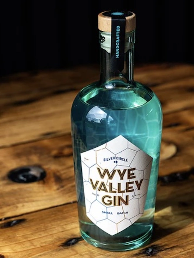  Wye Valley Gin, bottle of spirit on a wooden table. 