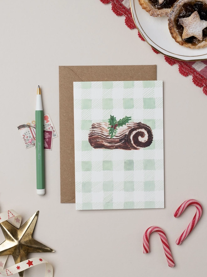 Christmas Yule Log Christmas Card on watercolour painted green gingham background