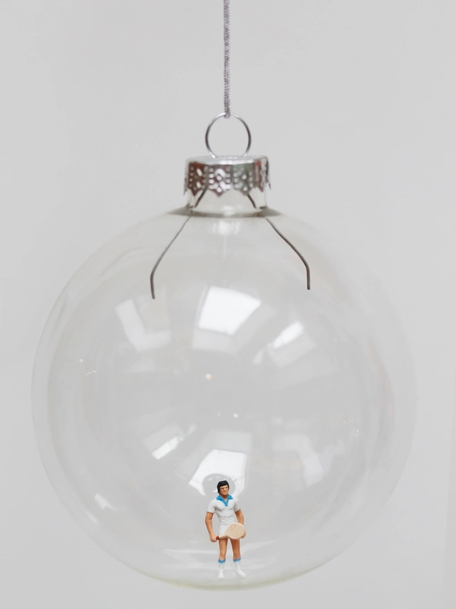 Miniature figure of a female tennis player in a glass Christmas bauble