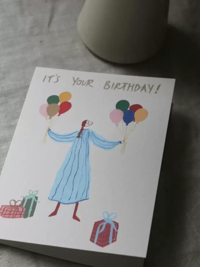 birthday card with girl and balloons and presents on
