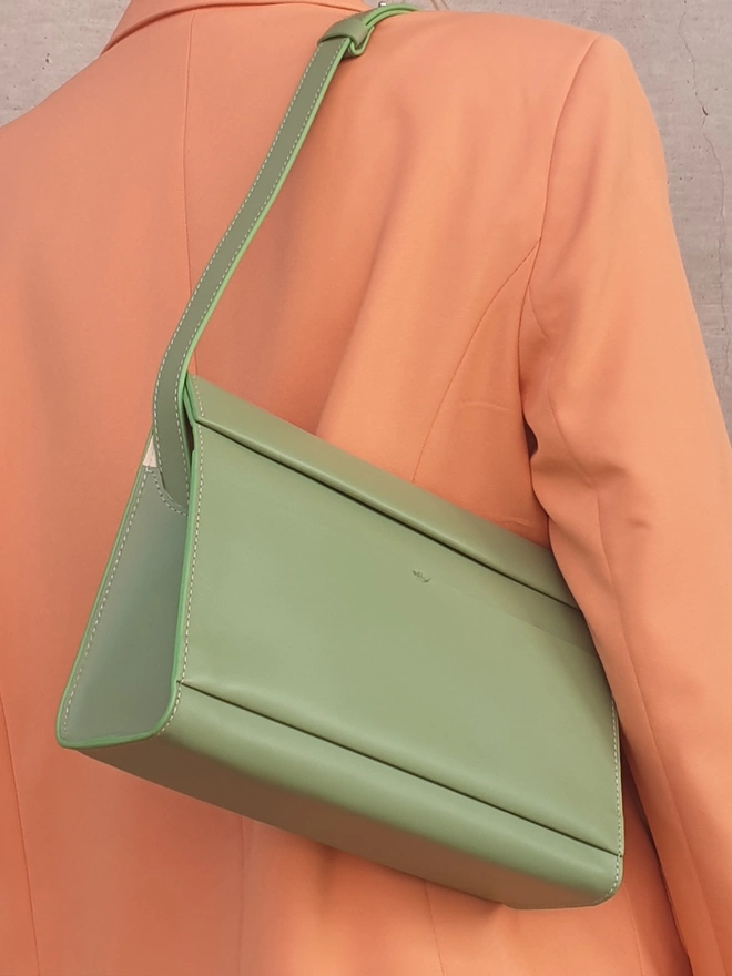 Sea Green Shoulder Bag worn on a Peace Blazer held underarm at shoulder length