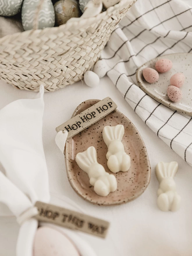 'hop hop hop' ceramic tag on an egg shaped plate