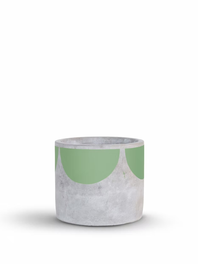 sunny concrete plant pot. a grey plant pot with a green half sun pattern painted around the top rim.