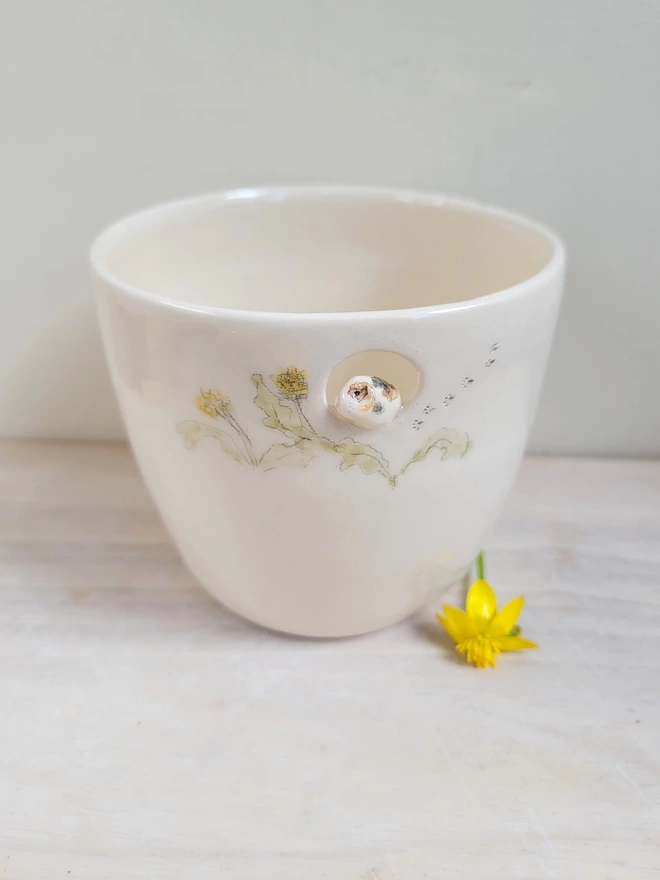 handle less tri colour guinea pig cup with hand painted dandelions, leaves and pawprints 