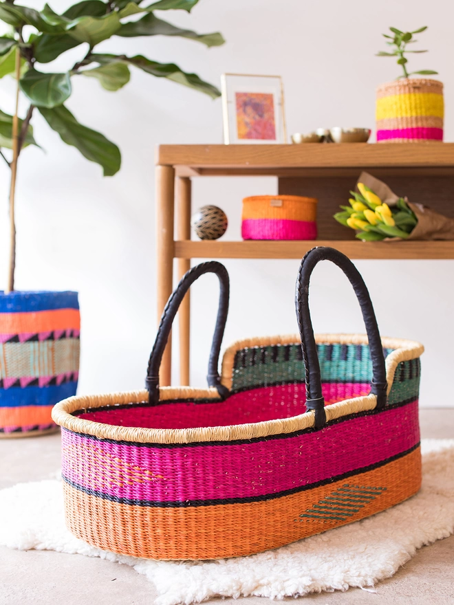 colourful moses basket pictured with other baskets