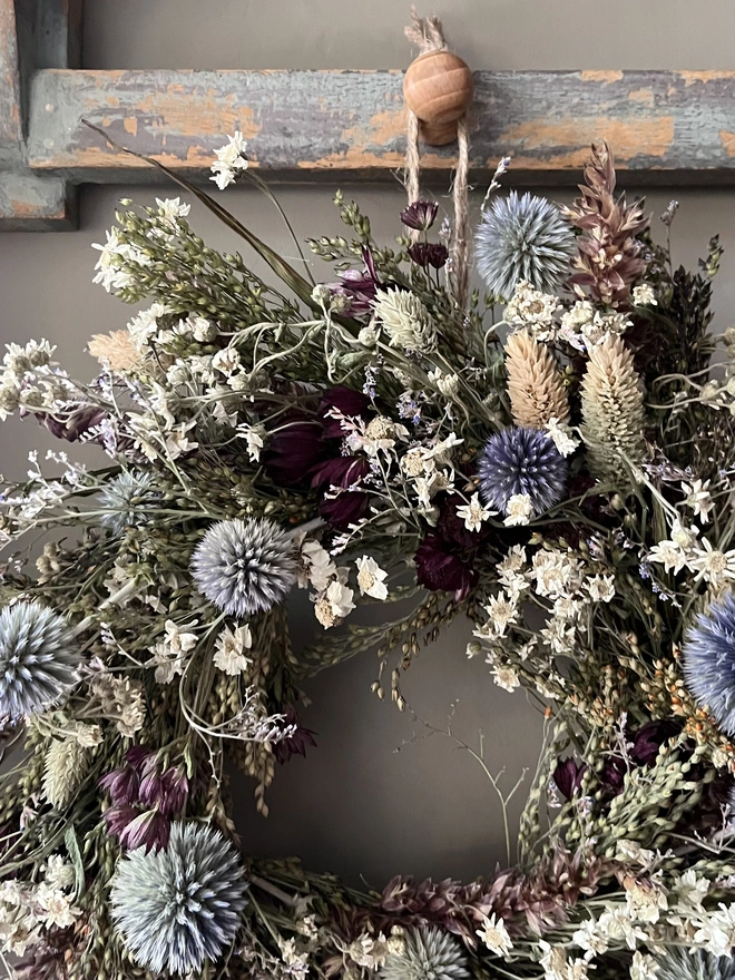 Dried Flower Winter Wreath hanging on kitchen wall 