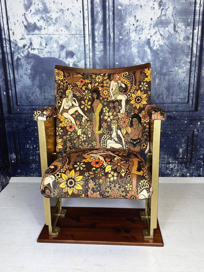 Refurbished vintage cinema seat upholstered in Summer of Love velvet.  The flip down part of the cinema seat is open.  The cinema seat has gold legs.