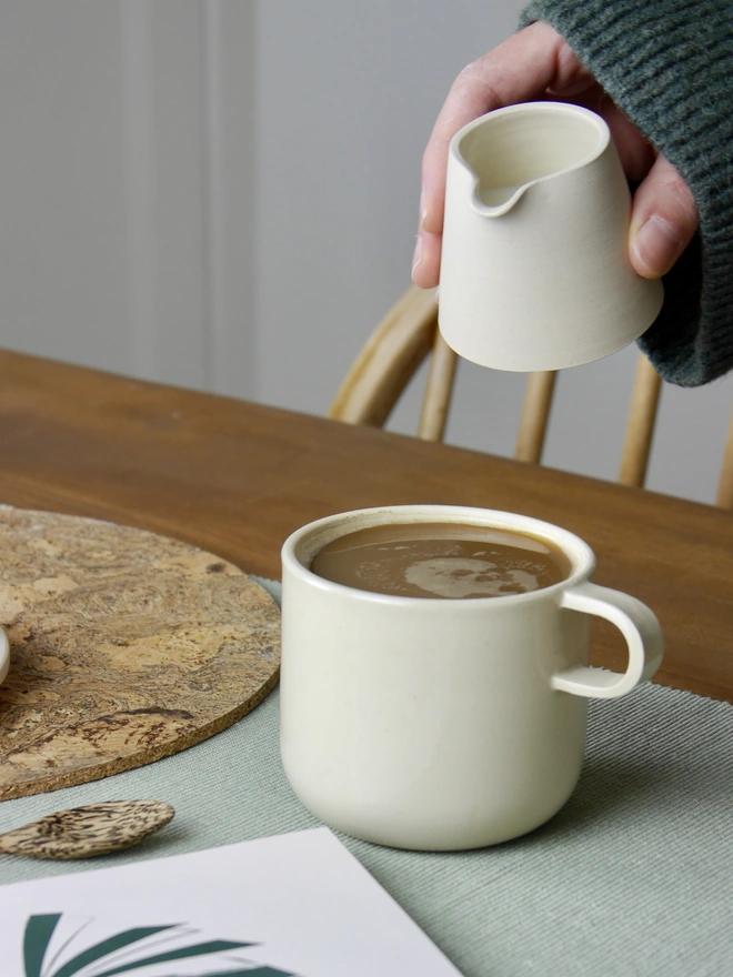 Ceramic Milk Jug in white being used