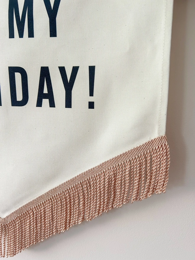 Rose gold fringe on a fabric birthday banner