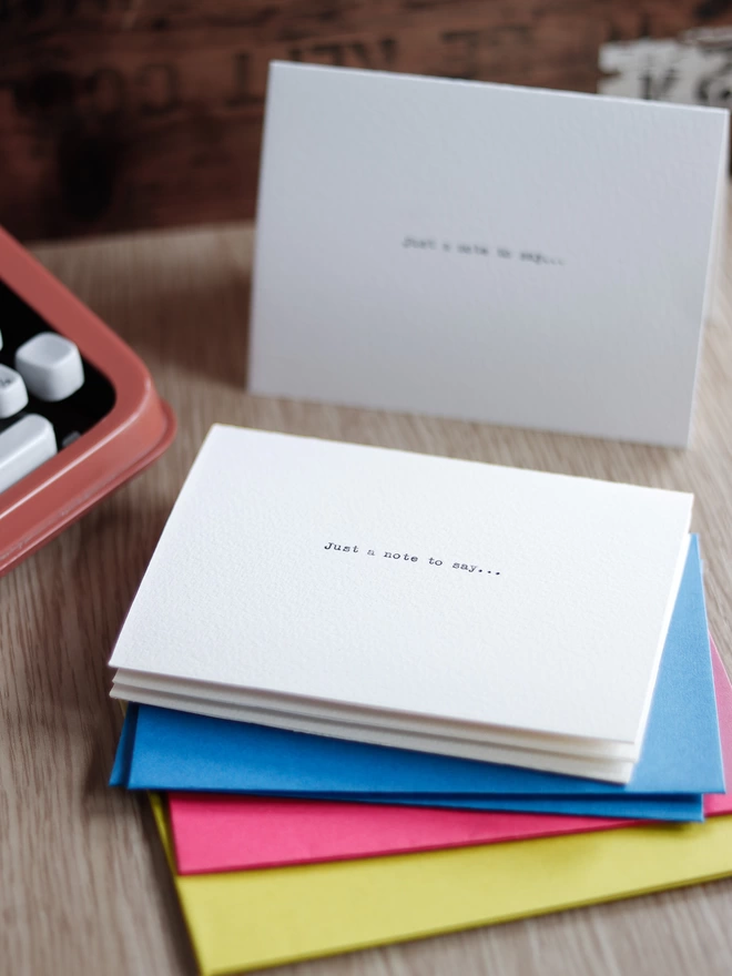 notecards with bright blue, pink and chartreuse envelopes