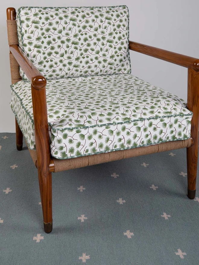 Manali Flatweave Rug, a colourful rug sitting in a living room. It is accompanied by other colourful furniture. 