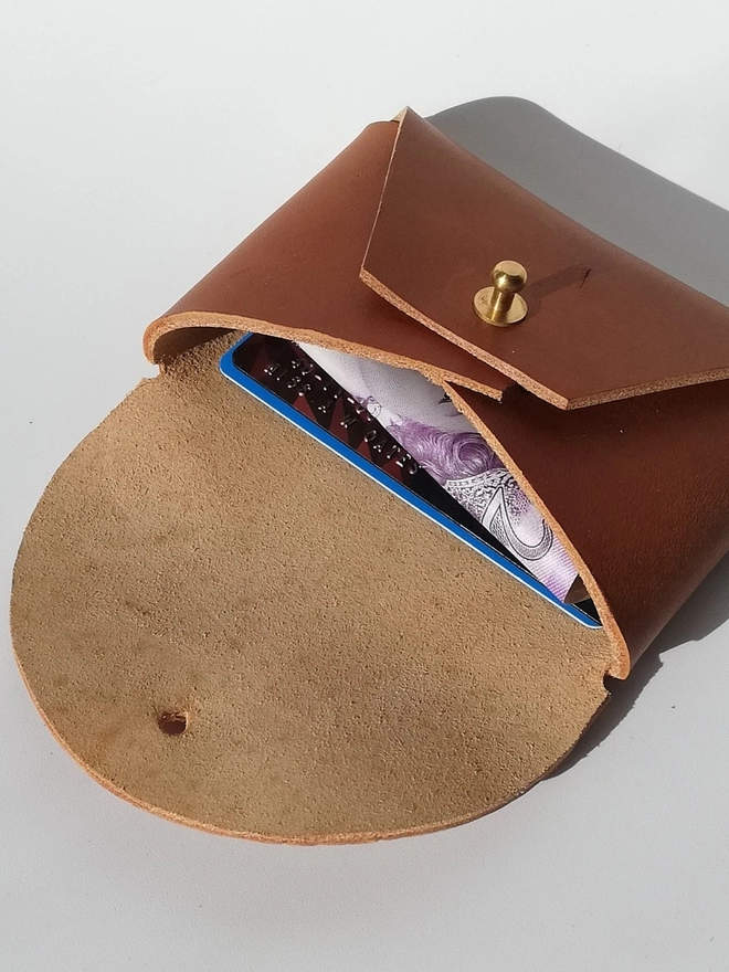 brown leather purse with cash