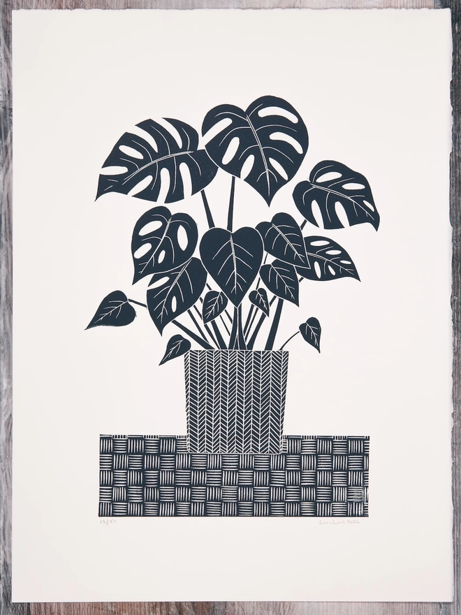 Picture of a Monstera Houseplant in a pot, taken from an original Lino Print 