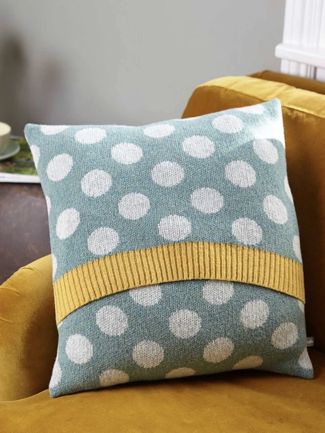 Lambswool Patterned Cushion, a cushion sitting on a yellow chair in a living room. 