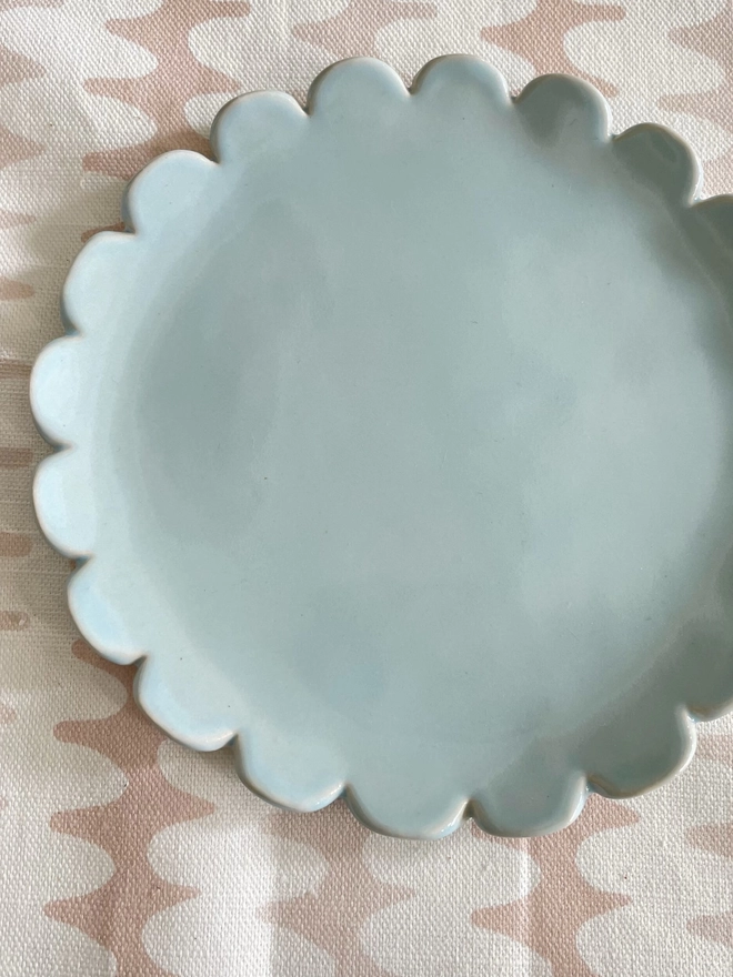 top view of camellia scallop edge side plate in heaven blue