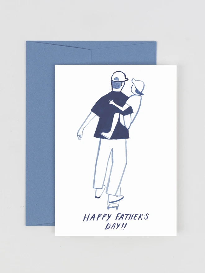 A greeting card featuring an ink drawing of a dad holding a child whilst skateboarding. The text on the card reads "Happy Father's Day"