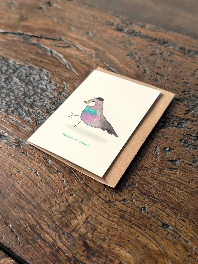 Angled view of a whimsical pigeon greeting card