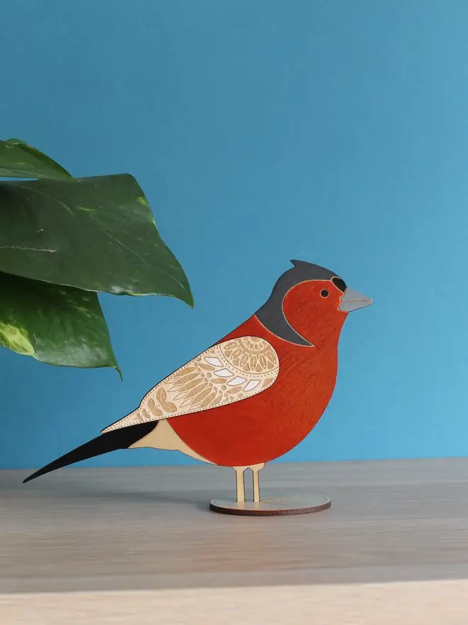 Standing Wooden Chaffinch, red wooden bird decoration standing on a platform. 