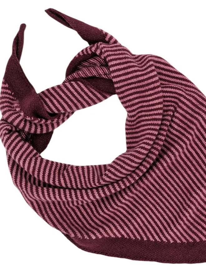 Lambswool Triangle Neck Scarf, a colourful neck scarf sitting on a white plain surface. 