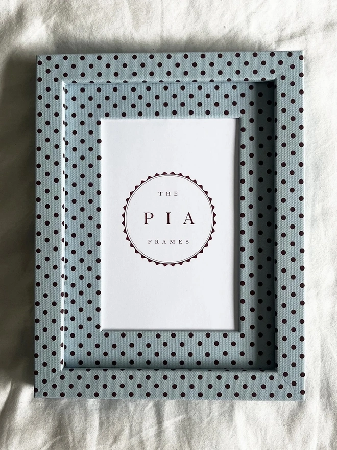 Blue & Burgundy Pembroke Dot Frame, a colourful dotted frame sitting on a plain white surface. 