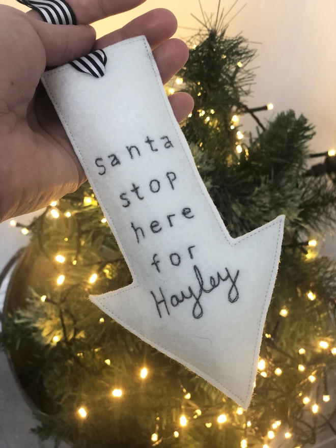 Santa Stop Here Personalised Christmas Decoration being held with lights